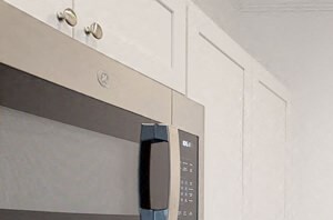 Kilsyth Court Apartments - Kitchen a kitchen with white cabinets and a stove and a sink